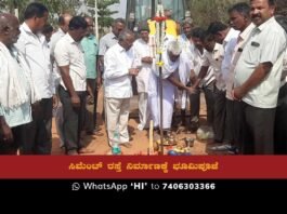 MLA V. Muniyappa speaking at the Bhoomi Puja ceremony for cement road construction under the Yettinahole and KL IDP projects.