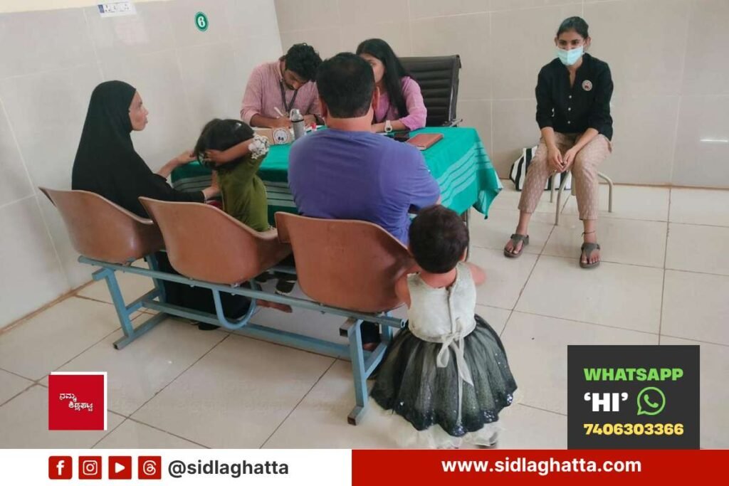 Doctors from St Johns Medical College counselling a family during a free developmental screening camp at Sidlaghatta government hospital
